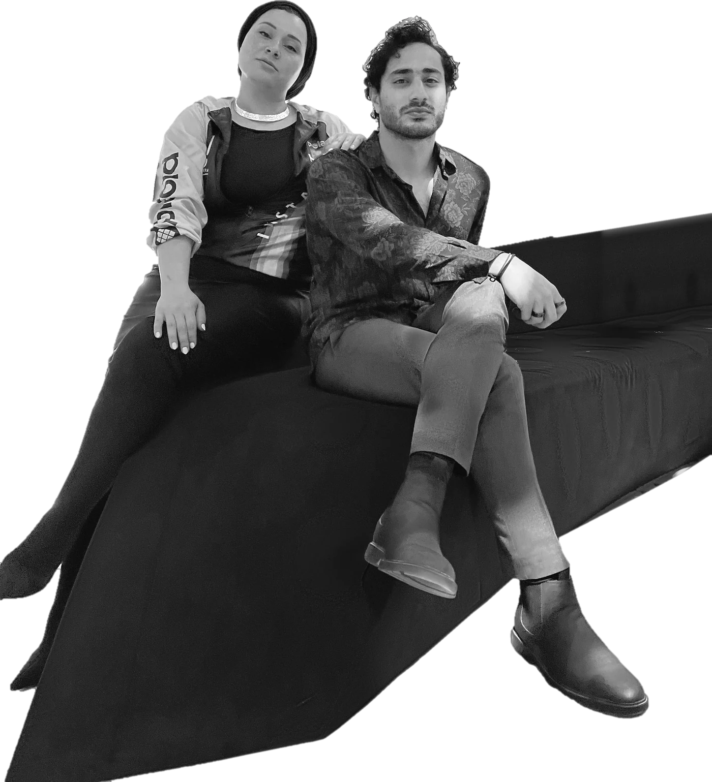 Dina Khataan and Mohamed Khataan of MOOG, seated on a velvet sofa