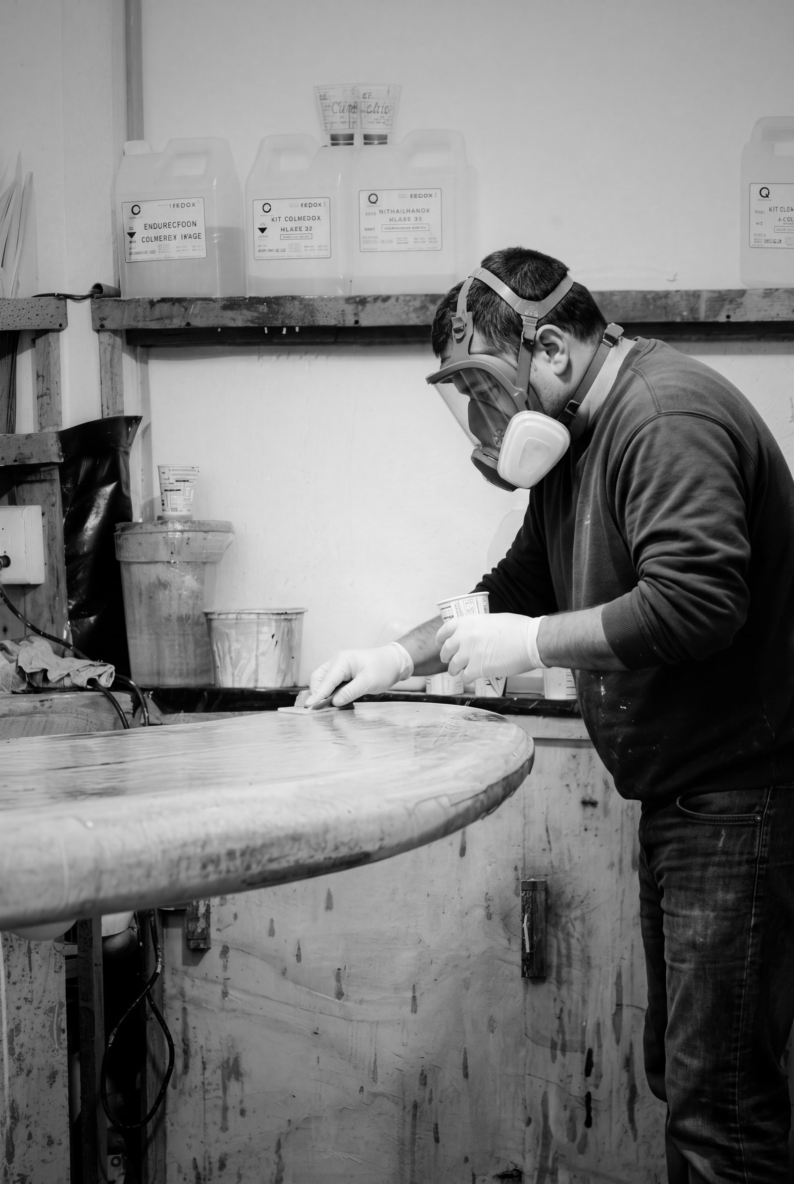 Craftsman in a mask finishing a cast resin surface in the MOOG workshop, Jebel Ali